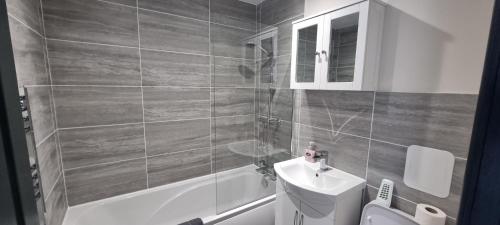 a bathroom with a sink and a toilet and a tub at Shirely S, Milton, Cambridge, 2BR House, Newly Refurbished in Milton