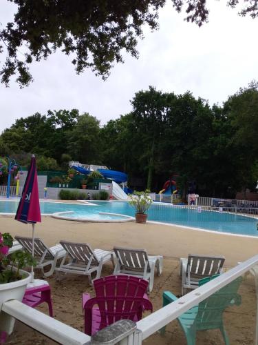 a group of chairs in front of a swimming pool at Mobil home 6-8 places St brėvin les pins 44 in Saint-Brevin-les-Pins