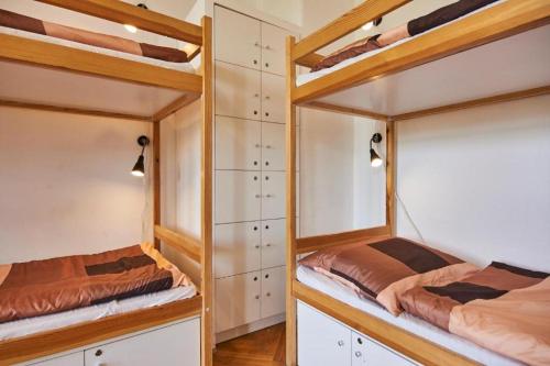 two bunk beds in a room with wooden floors at B3 Hostel Budapest in Budapest