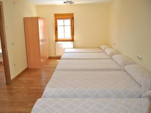 a row of beds in a room with a window at Holiday home Casa las Margaritas in Salamanca