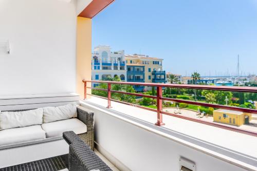 a balcony with a couch and a view of the city at Limassol Marina Nereids D22 by Ezoria Villas in Limassol