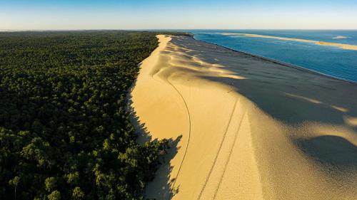 an aerial view of a sandy beach next to the ocean at Holiday Inn - Bordeaux-Merignac by IHG in Mérignac
