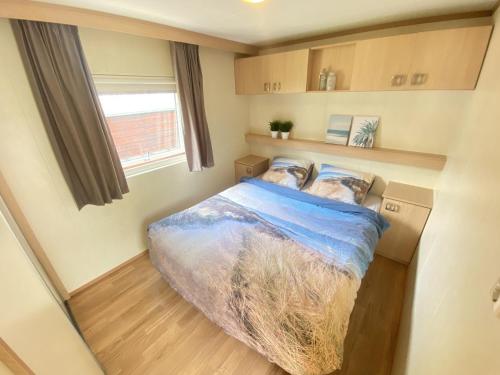 a bedroom with a bed in a small room at Beach Resort Kamperland - 1653 in Kamperland