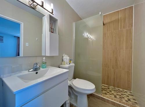 a bathroom with a sink and a toilet and a shower at Sunny Moon Vacation, Private Island in Fajado,PR. in Fajardo