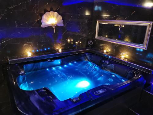a jacuzzi tub in a dark room with lights at Wellness Stodolni Ostrava in Ostrava