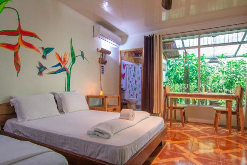 um quarto com uma cama com um quadro na parede em Santuario de Ranas - Explora nuestro paraíso natural em San Lorenzo