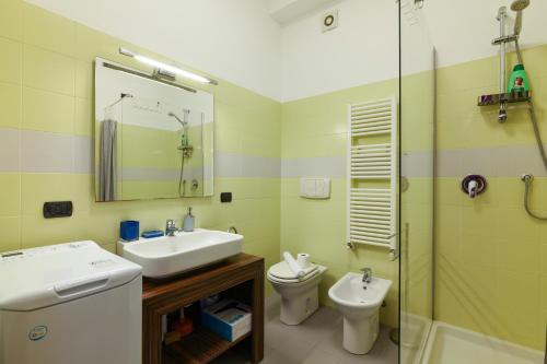 a bathroom with a sink and a toilet and a shower at PrimoPiano - Gargano in Milan