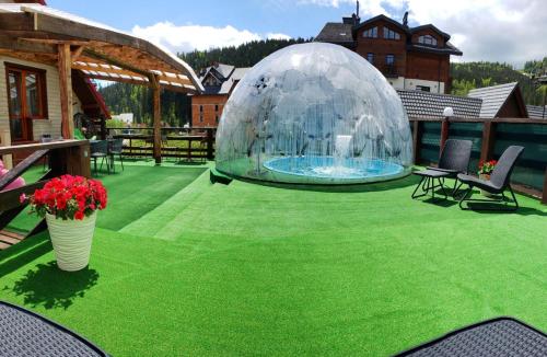 a bubble dome on a lawn with a swimming pool at Zdybanka in Bukovel