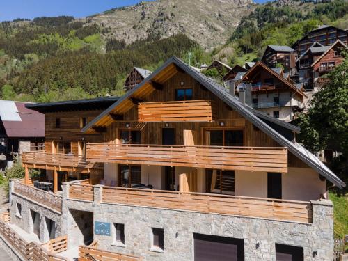 a house in the mountains with a balcony at TERRESENS - L'ETENDARD in Vaujany