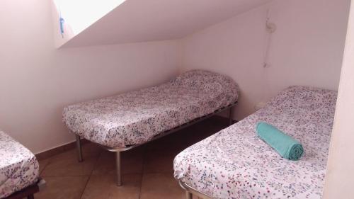 a room with two beds and a green pillow in it at La Quercia Fiorita in Trivolzio