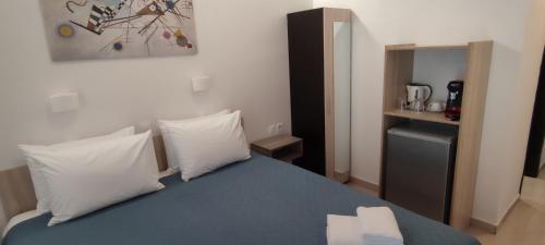 a bedroom with a bed with two pillows at Afroditi Hotel in Plakias