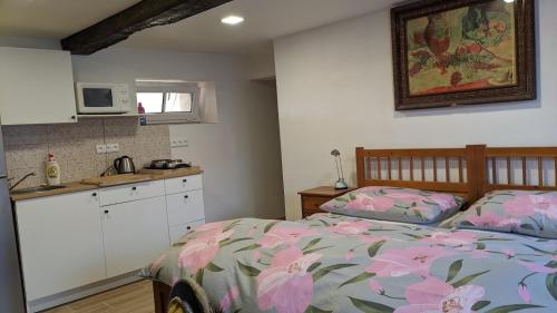 a bedroom with a bed and a kitchen in it at Chalupa u rybníka Střehom in Dolní Bousov
