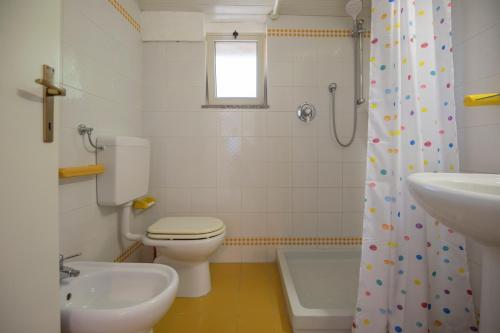 a bathroom with a toilet and a sink and a shower at HelloElba Villetta Azzurra in Portoferraio