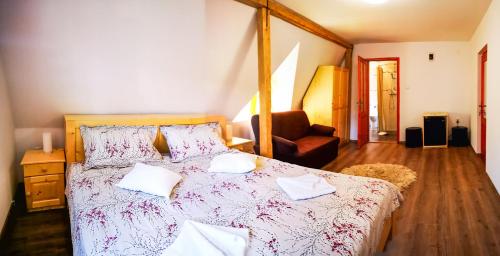 a bedroom with a large bed with pillows on it at Casa Camelia in Sovata