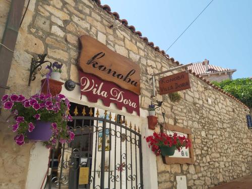 a building with a gate and flowers on it at Vila Dora Supetar in Supetar