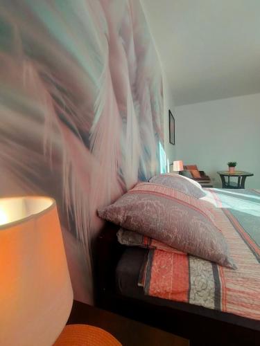 a bedroom with a bed with a painting on the wall at Apartamenty Częstochowa in Częstochowa