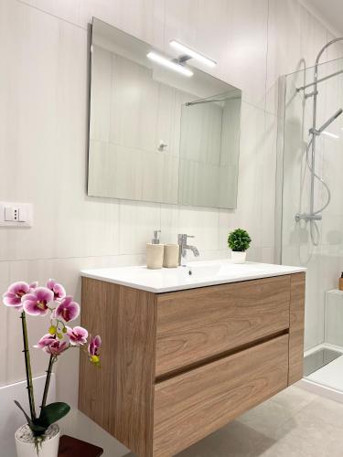a bathroom with a sink and a mirror at Casa Le Volte by Ferrocino Holiday in Nardò