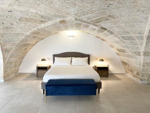 a bedroom with a bed in a brick wall at Casa Le Volte by Ferrocino Holiday in Nardò