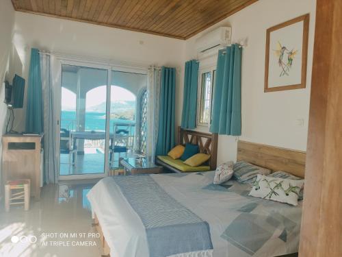 a bedroom with a bed and a view of the ocean at Villa bel azur in Antsiranana
