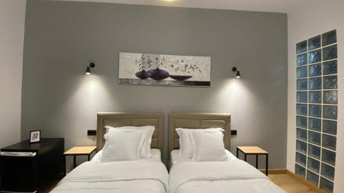 two beds sitting next to each other in a bedroom at Vila Jasmine in Tirana