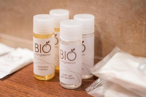 three bottles of moisturizers sitting on a table at Fuente del Miro in Valderrobres