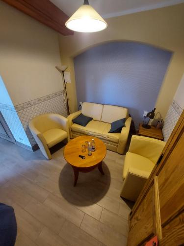 a living room with a couch and a table at Folwark Hutta in Suwałki