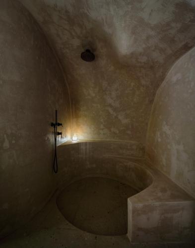 a dark room with a cross on the wall at Agnadema Apartments in Firostefani