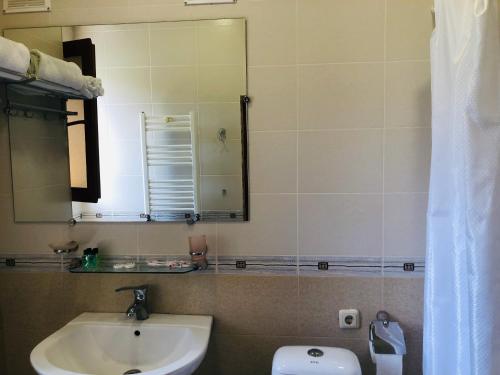 a bathroom with a sink and a mirror at Dil Hill by Sam in Dilijan