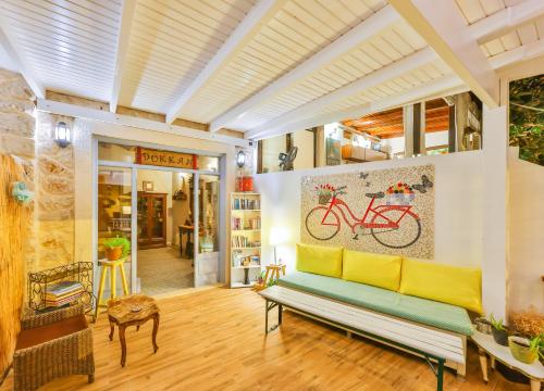 a living room with a bench and a painting of a bike at DuruPduru Kaş in Kas