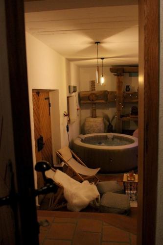 a bathroom with a tub and a chair in a room at Wooden fairytale in Lesično