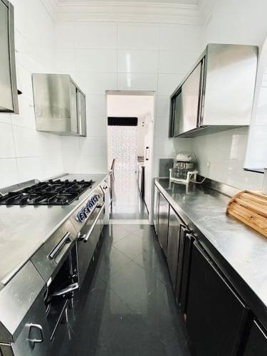 a kitchen with a stove and a counter top at Velver Mansion, Malta - Luxury Villa with Pool in Naxxar