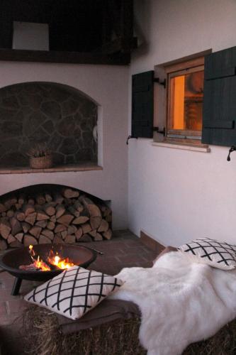 a living room with a fireplace and a fire pit at Wooden fairytale in Lesično