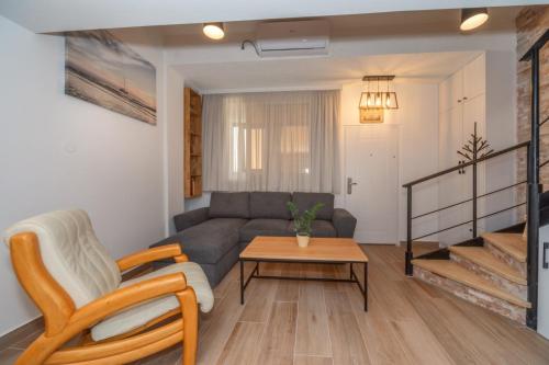 a living room with a couch and a table at La Costa Apartments in Bar