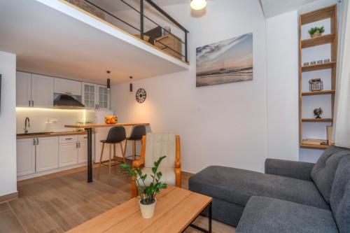 a living room with a couch and a table at La Costa Apartments in Bar