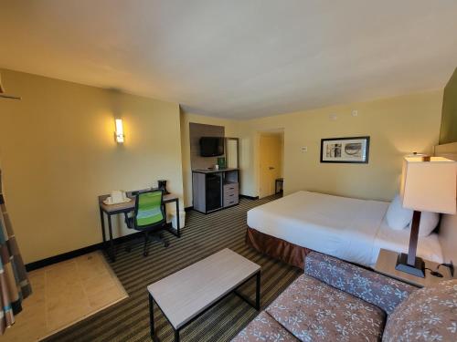 a hotel room with a large bed and a couch at Quality Inn Flamingo in Atlantic City