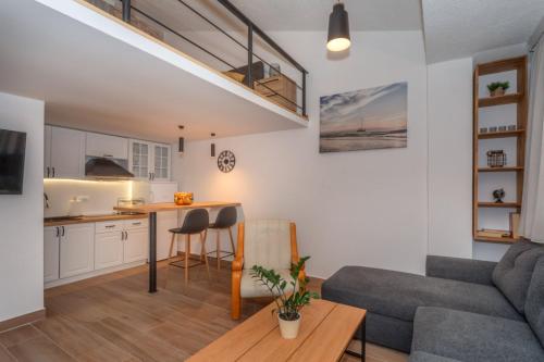 a living room and kitchen with a couch and a table at La Costa Apartments in Bar