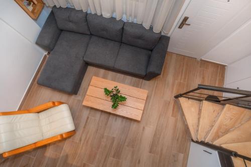 an overhead view of a living room with a couch and a table at La Costa Apartments in Bar