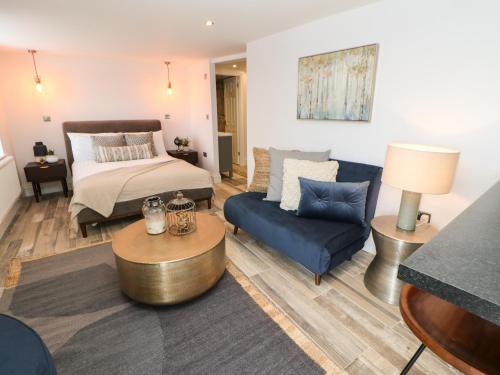 a living room with a bed and a couch at The Beach Apartment in South Shields