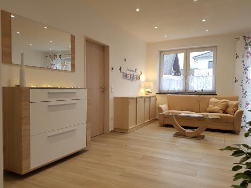 a kitchen and living room with a couch and a table at Ferienhaus MoselCharme in Alken
