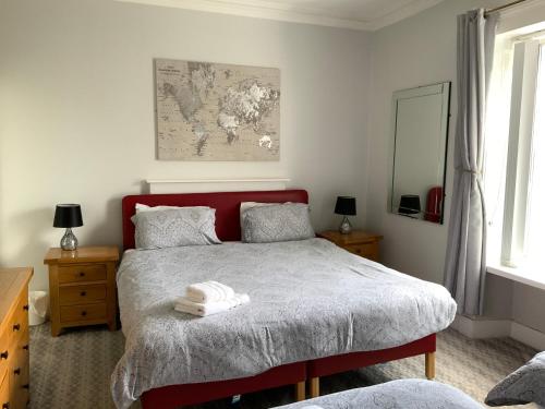 a bedroom with a bed and a map on the wall at Southbank Guesthouse in Elgin