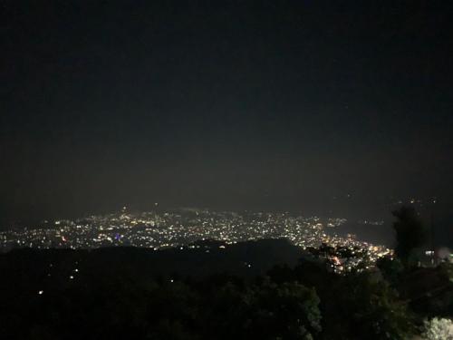 a view of a city at night at Hotel Pristine Himalaya in Pokhara