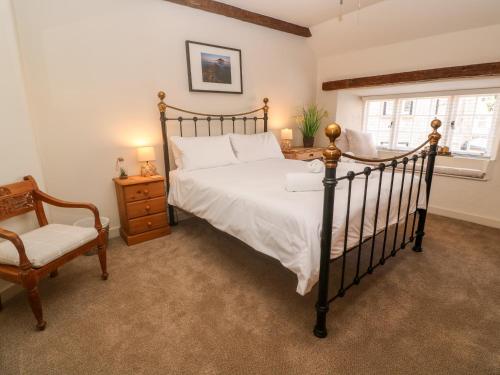 Penhale Cottage tesisinde bir odada yatak veya yataklar
