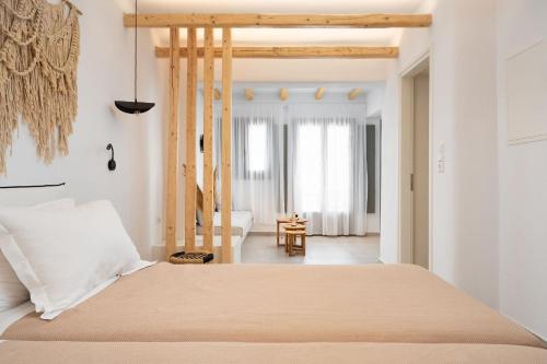 a bedroom with a bed and a living room at Melidron Hotel & Suites in Agios Prokopios