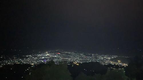 an aerial view of a city at night at Hotel Pristine Himalaya in Pokhara
