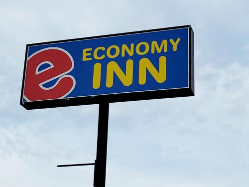 a sign for an economy inn on a pole at Economy inn in Corning