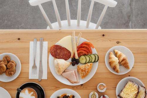 a tray with plates of food on a table at Melidron Hotel & Suites in Agios Prokopios