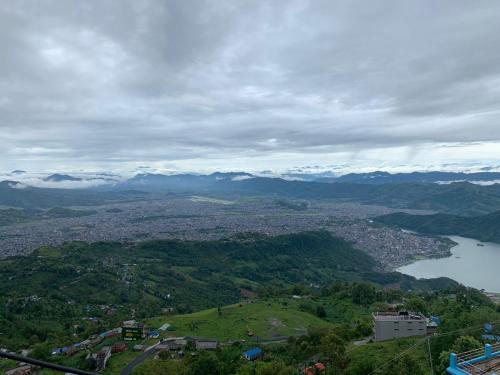 a view of a city and a lake and mountains at Hotel Pristine Himalaya in Pokhara