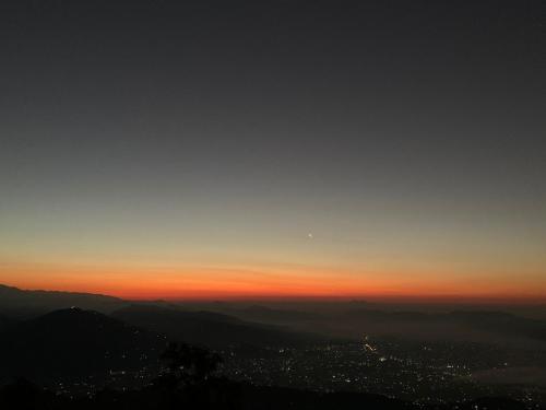 a view of the sunset from the top of a mountain at Hotel Pristine Himalaya in Pokhara
