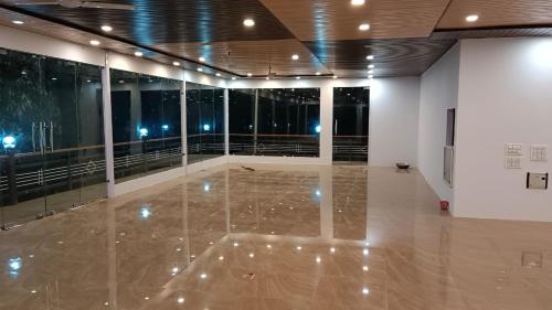 a large room with a marble floor and glass walls at OM The Divine Soul of Devbhumi in Gupta Kāshi