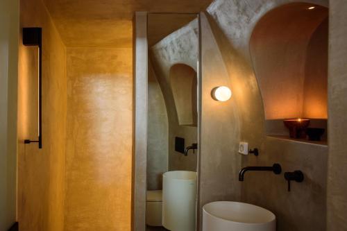 a bathroom with a toilet and a sink at Agnadema Apartments in Firostefani
